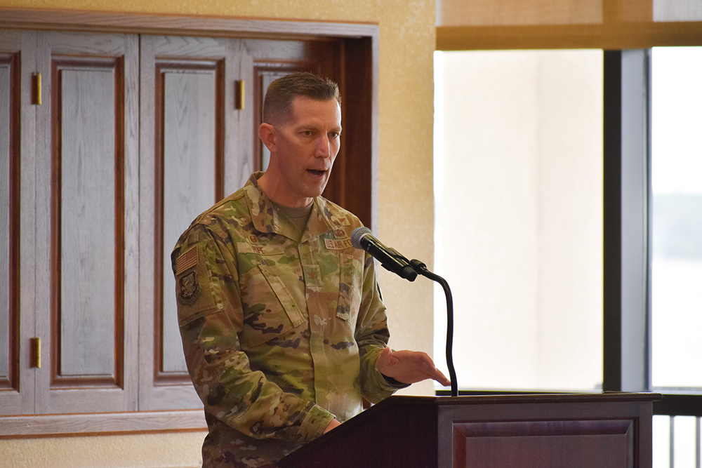 Col. Billy Pope speaks, dressed in uniform at a podium