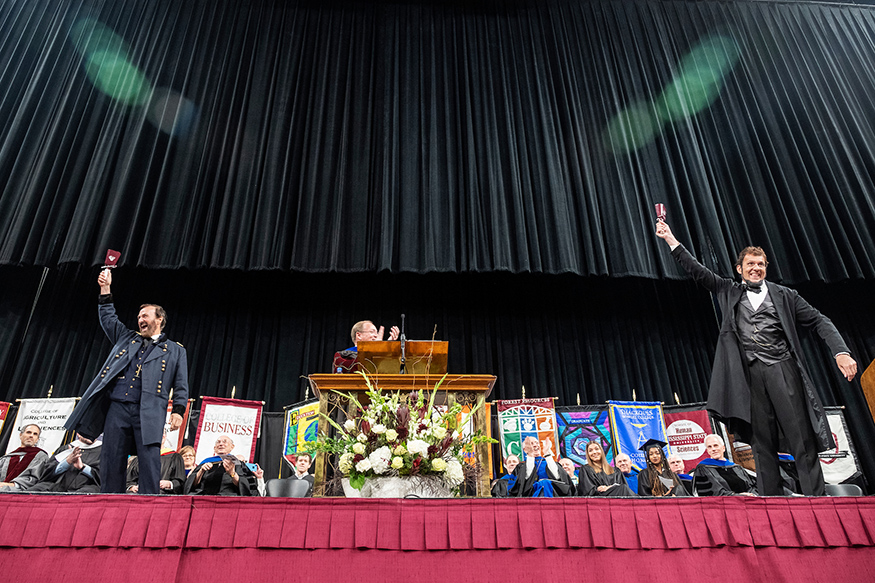 Abraham Lincoln and Ulysses S. Grant ring cowbells at MSU's Fall Convocation.