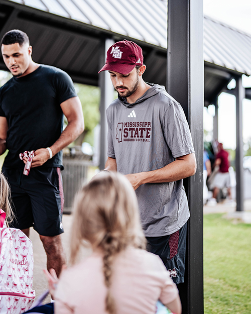Nick Barr-Mira and other MSU football players visit a local elementary school.