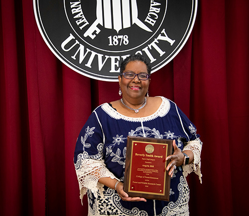 Angela Hill holds the CFR/FWRC Beverly Smith Support Staff Award