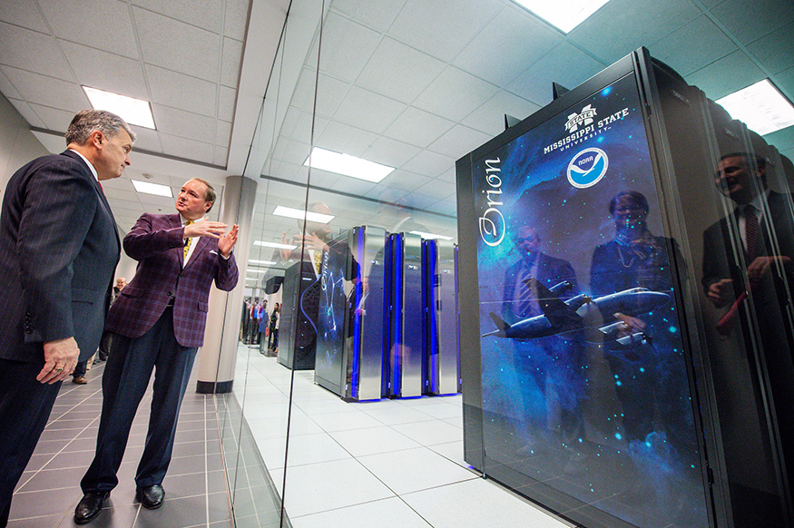 Mark Keenum and Craig McLean talk in front of MSU's Orion Supercomputer