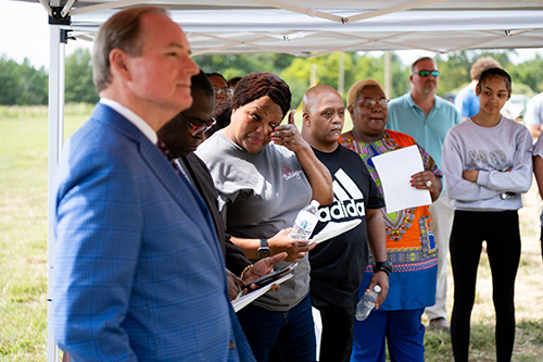 Twana Hubbard wipes away tears at the groundbreaking of the 15th Maroon Edition Habitat home.