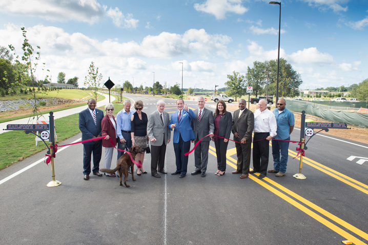 Officials celebrated the opening of Hail State Boulevard with a ribbon cutting Friday [Sept. 1]. Pictured, from left to right, are Oktibbeha County District 5 Supervisor Joe Williams, Starkville Mayor Lynn Spruill, Eutaw Construction founder and former president Thomas S. Elmore and Jean Elmore, Central District Transportation Commissioner Dick Hall, MSU President Mark E. Keenum, Northern District Transportation Commissioner Mike Tagert, Oktibbeha County District 4 Supervisor Bricklee Miller, Oktibbeha County District 3 Supervisor Marvell Howard, MSU College of Agriculture and Life Sciences Dean George Hopper and Oktibbeha County District 2 Supervisor Orlando Trainer.  (Photo by Megan Bean)