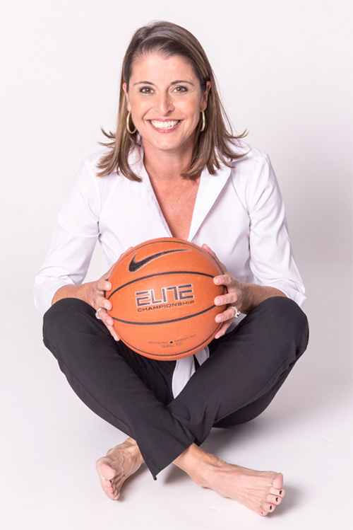 Joanne McCallie holding a basketball