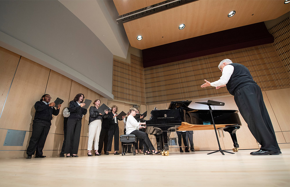 An ensemble sings with a piano accompanying