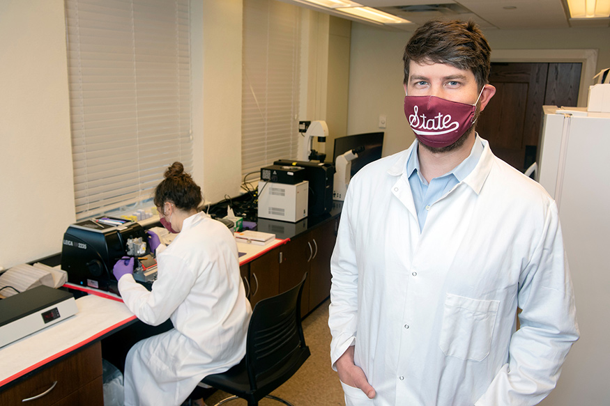 Andrew K. Lawton is pictured in his MSU laboratory as Peyton York, a senior biochemistry major from McKinney, Texas, slices cerebellar sections using a microtome. 