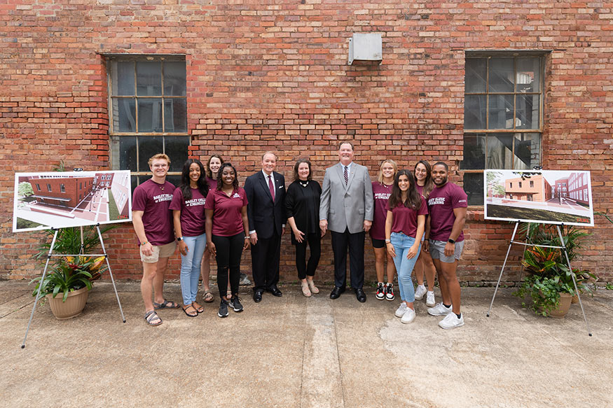 MSU students gather with MSU President Mark E. Keenum, center left, and MSU petroleum engineering graduate Randy J. Cleveland, center right, and his wife Nina at the soon-to-be refurbished location for the Cleveland Engineering Student Center.