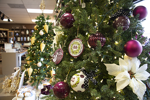 A Christmas tree decorated in maroon and white ornaments at the University Florist