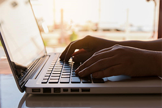 hands on a laptop