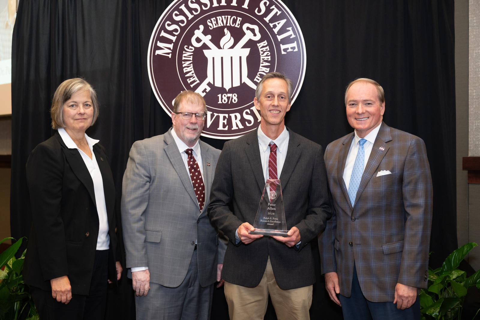 Pictured from left to right are MSU Vice President for Research and Economic Development Julie Jordan, Vice President for the Division of Agriculture, Forestry and Veterinary Medicine Keith Coble, 2024 Ralph E. Powe Research Excellence Award winner Peter Allen and MSU President Mark E. Keenum.