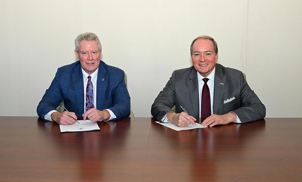 University of Mississippi Chancellor Glenn Boyce, left, and Mississippi State University President Mark E. Keenum celebrate a new agreement allowing qualified MSU students to enter UM’s Juris Doctor program before fully completing an MSU bachelor’s degree, accelerating the total length of undergraduate studies plus law school by one full year.