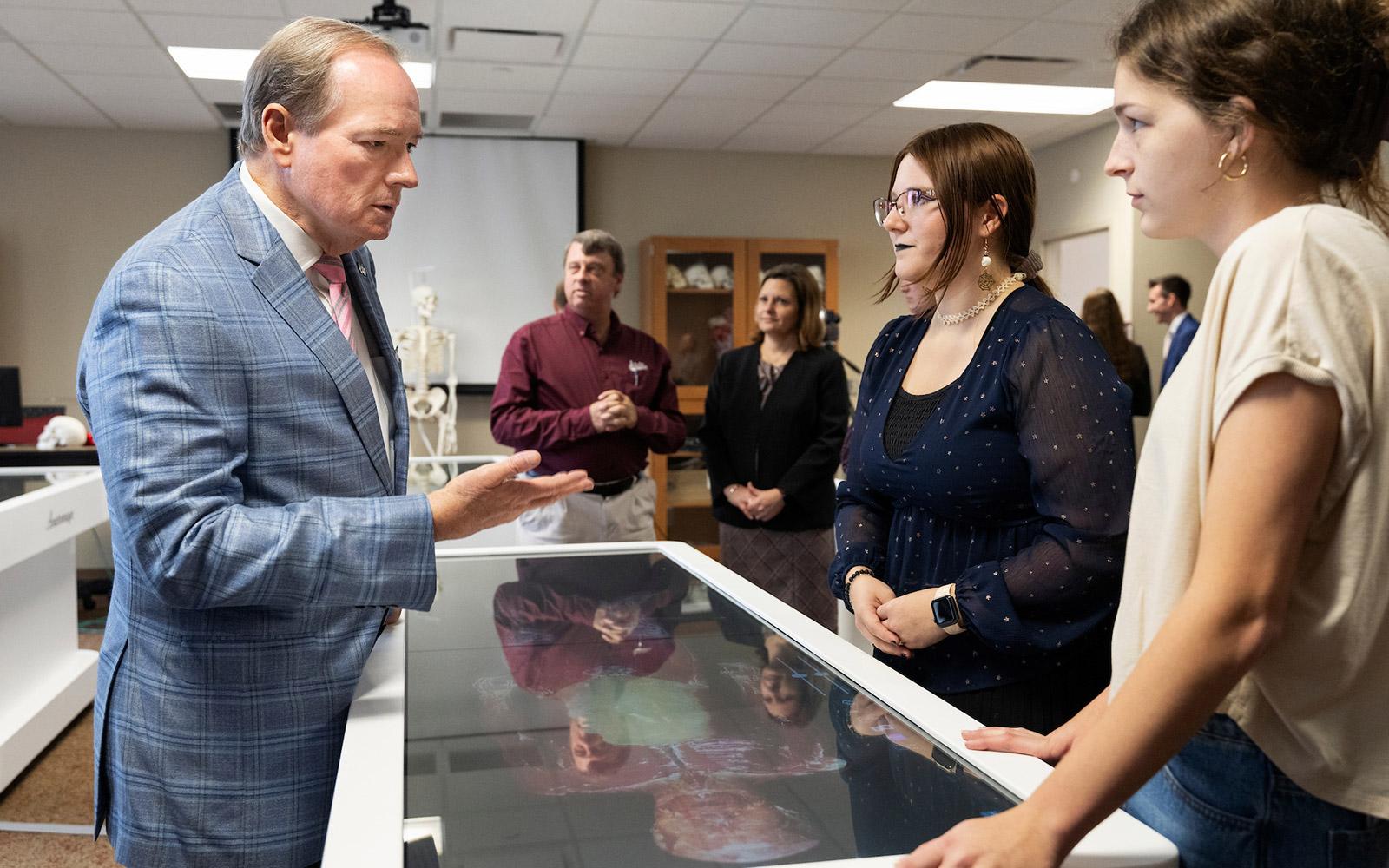 Mississippi State University President Mark E. Keenum observes the Anatomage Tables, the latest addition to MSU’s Department of Biological Sciences curriculum. The university hosted a ribbon-cutting ceremony Thursday [Oct. 31] to unveil this advanced digital tool, which offers students an interactive and precise way to explore human anatomy using the latest in medical education technology.