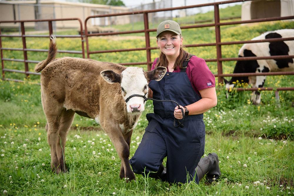 Katie Jones, a 2023 DVM graduate of MSU’s College of Veterinary Medicine is pictured while working as part of her farm animal medicine rotation.