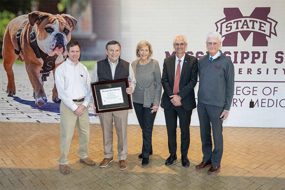 Congratulating Dr. John G. “Rusty” Thornton, second from left, on obtaining his Mississippi State University diploma, which he earned in the 1960s, are, from left, College of Veterinary Medicine Associate Dean Jack Smith, (Thornton), his wife Stephanie Thornton, CVM Dean Nicholas Frank, and Executive Vice Provost for Academic Affairs Peter Ryan.