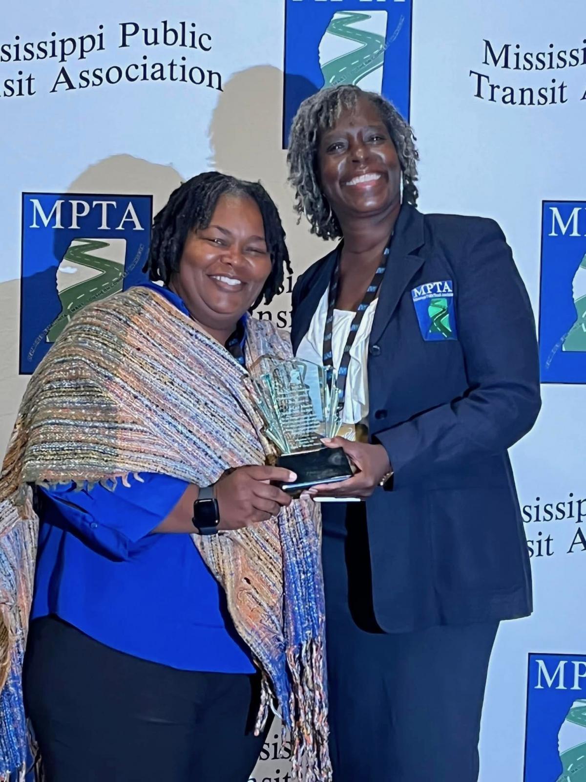 Mississippi State S.M.A.R.T. transit operator, left, accepts the Community Service Award during the Mississippi Public Transit Association’s recent conference. MSU won three driver awards, Rural General Public Transit System of the Year and Innovative Agency of the Year. (Submitted Photo).