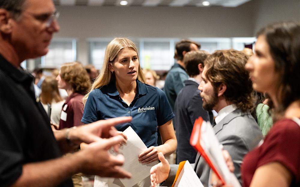 Employers and students discuss job opportunities at a career expo.