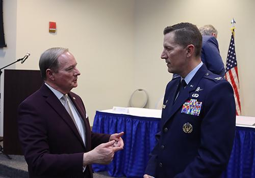 MSU President Mark E. Keenum speaks with USAF Col. Billy Pope, Jr. (Photo by James Carskadon)