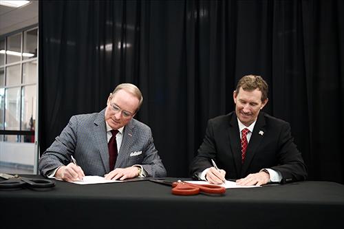 Mississippi State University President Mark E. Keenum, left, and East Mississippi Community College President Scott Alsobrooks sign a Memorandum of Understanding Wednesday [Jan. 29] to formalize the MSU at the Communiversity partnership through the Advancements in Manufacturing Upskilling Program.