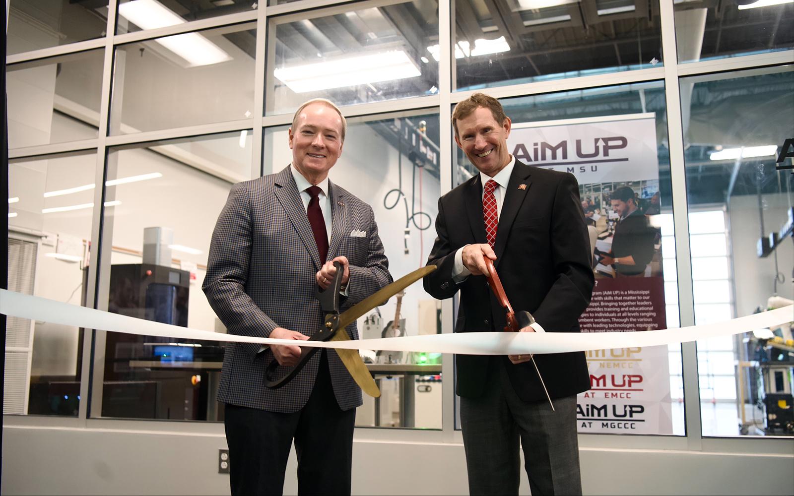 Mississippi State University President Mark E. Keenum, left, and East Mississippi Community College President Scott Alsobrooks cut the ribbon Wednesday [Jan. 29] for the MSU at the Communiversity partnership through the Advancements in Manufacturing Upskilling Program, better known as AiM UP.