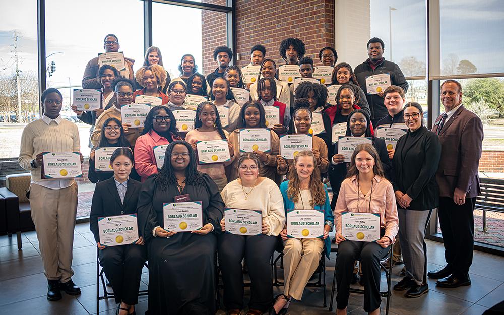 Mississippi State and World Food Prize Foundation representatives pose with high school students from across the state as they hold certificates.