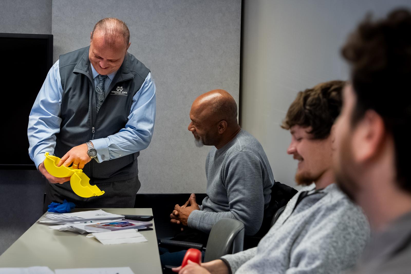Environmental and Industrial Safety Trainer Robert Noah, left, demonstrates proper lockout and tagout practices during Mississippi State’s Center for Continuing Education Asbestos Inspection and Assessment Initial Training. (Photo by Jared Jones