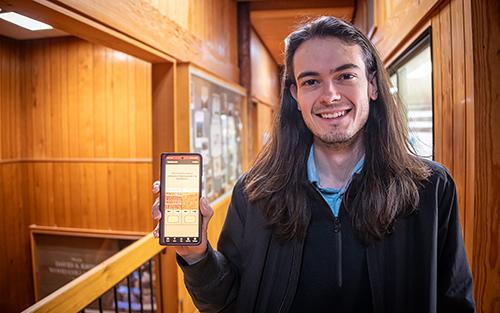 Kyatt Spessert, a sustainable bioproducts master’s student from Elkins, West Virginia, shows the WhatWood? app on a smartphone.