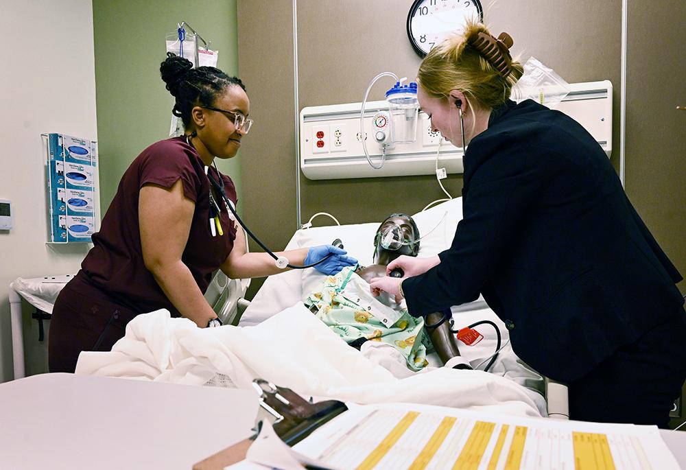 MSU-Meridian students tend to a simulated patient.