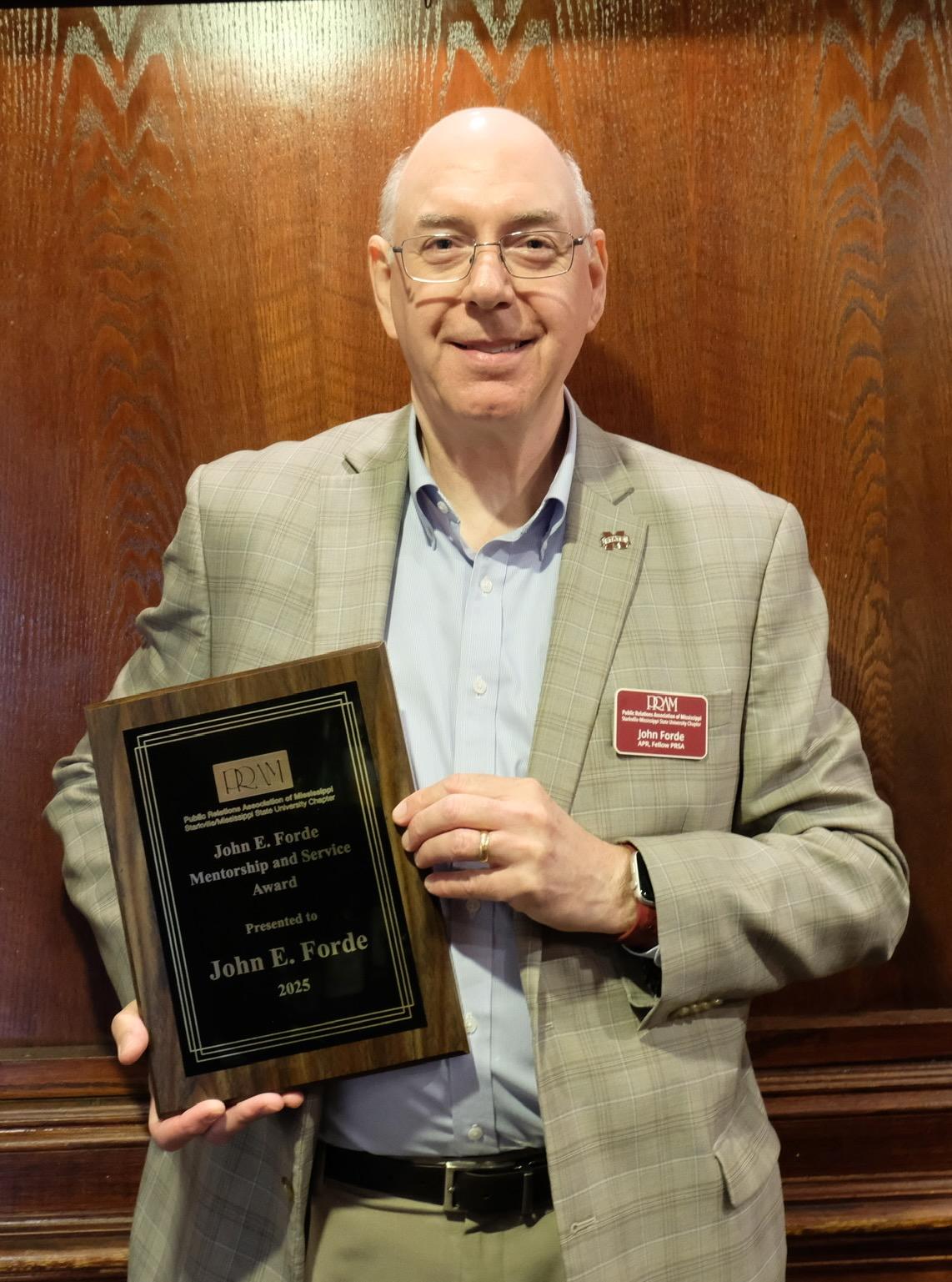 John Forde holds and award