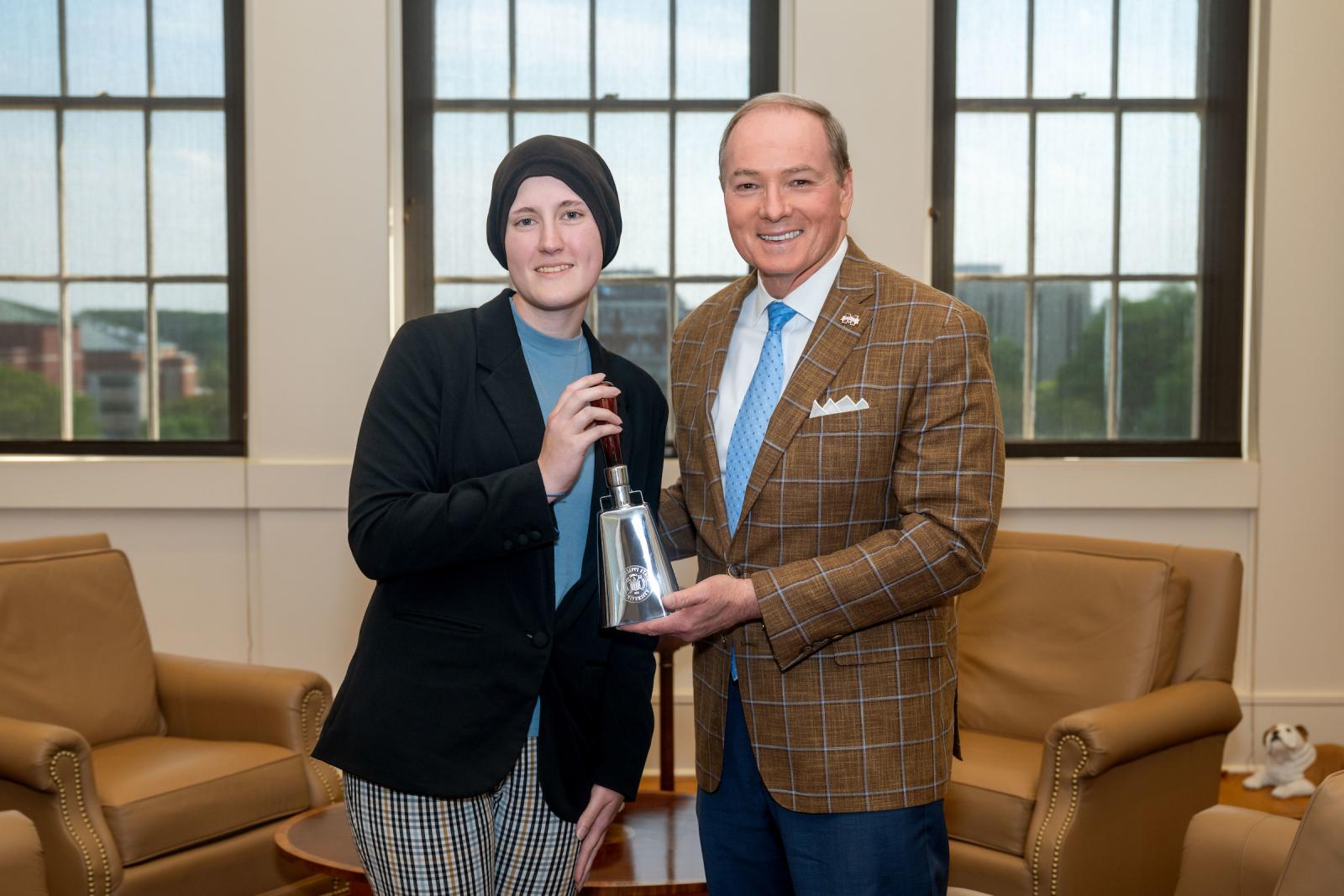 Mississippi State President Mark E. Keenum presents junior Claire Green with a commemorative cowbell to celebrate her becoming the university’s 20th Truman Scholar. (Photo by Emily Grace McCall)