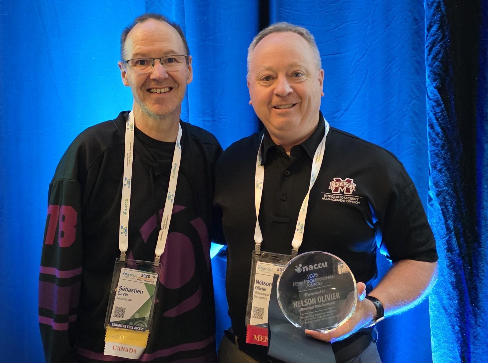 two men standing with an award