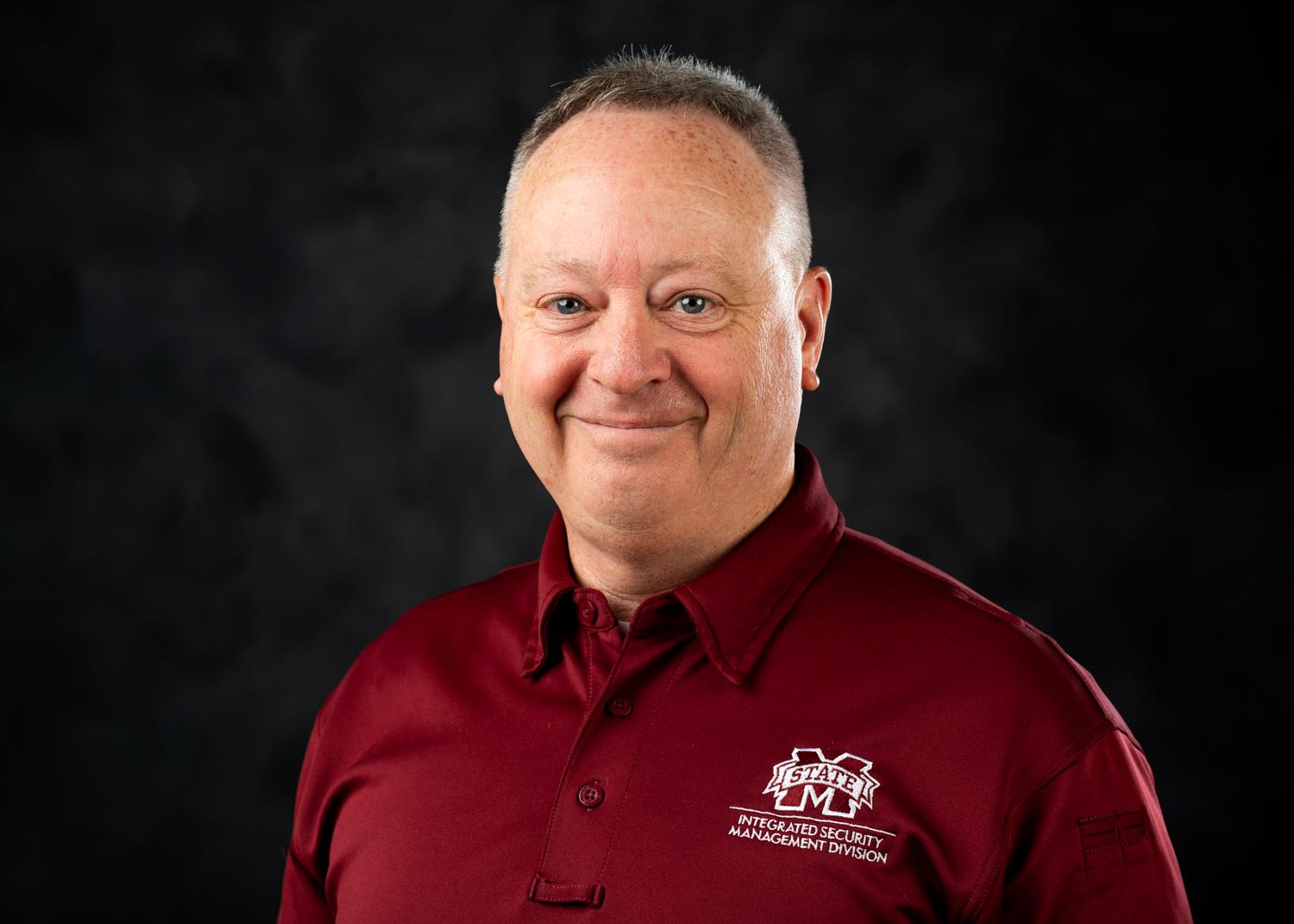 photo of man in maroon shirt