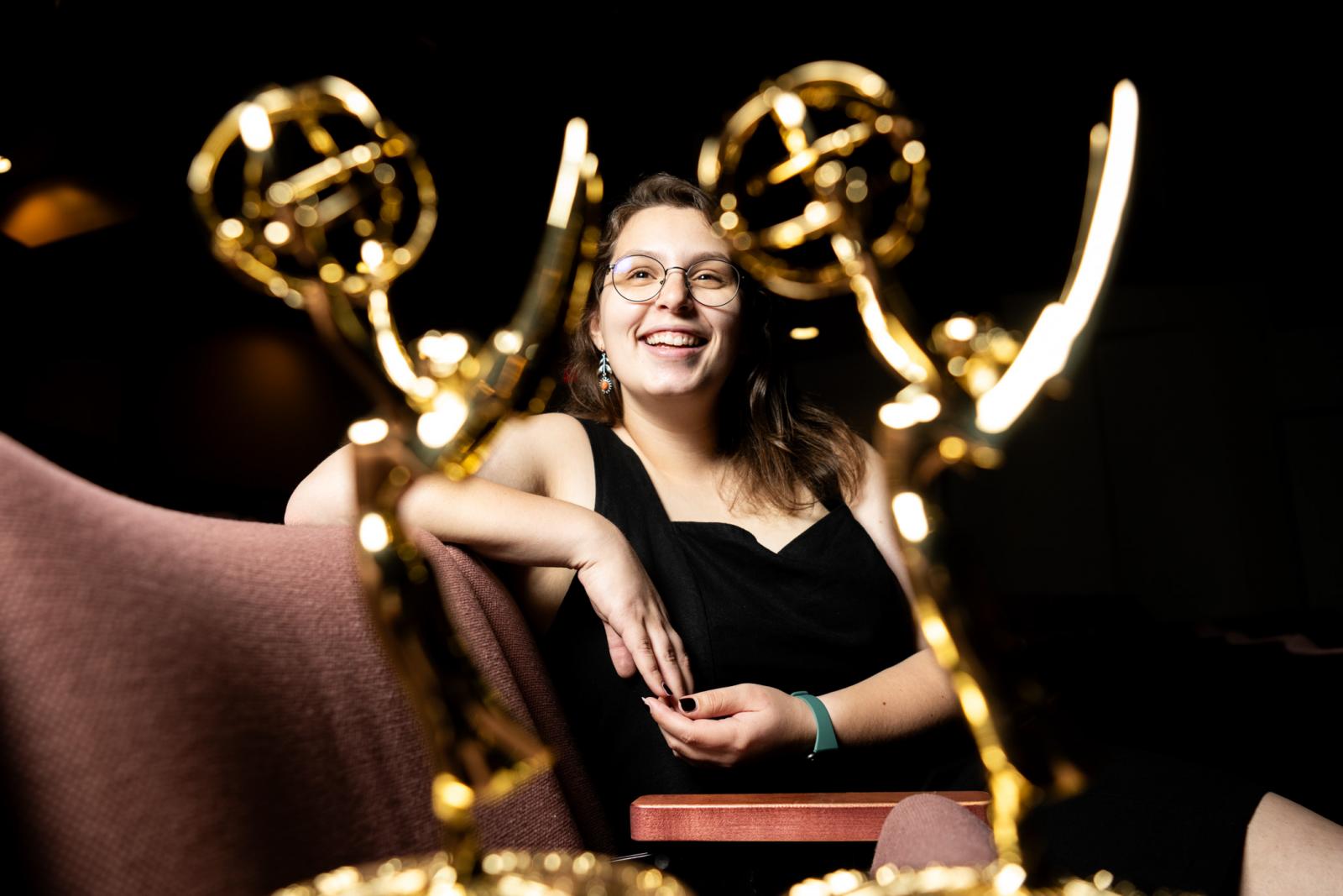Portrait of Olivia Aylsworth with Emmy Awards in foreground by Grace Cockrell