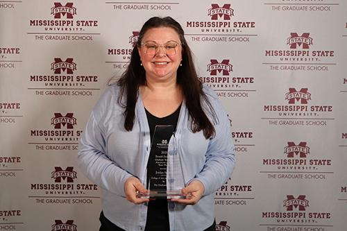 Jordan Smink poses with an award.