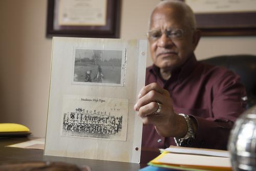 Richard Holmes poses in 2016 with memorabilia in his home office.