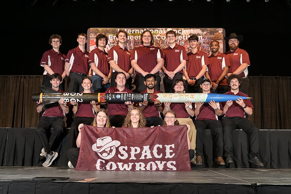 Members of Mississippi State’s Space Cowboys Rocketry Team pose with Helios, a rocket named after the Greek sun god.