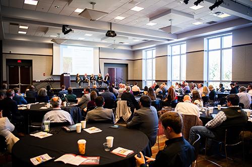 Attendees of the inaugural Pathways to Resilience Summit at Mississippi State in 2024 are pictured sitting at tables and listening to a speaker.