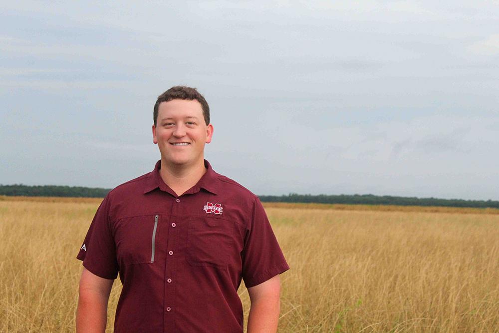 Dalton Whitt, a Mississippi State doctoral student, poses in a field.