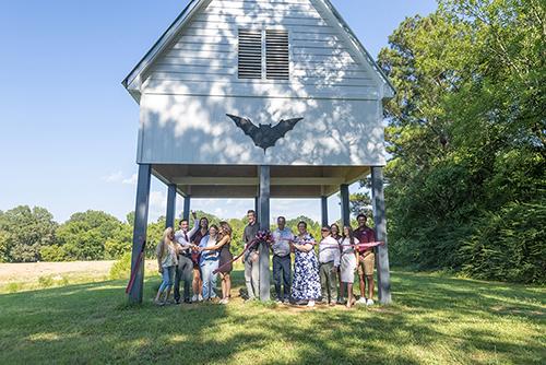 Mississippi State students, graduates, faculty and administrators celebrate the opening of a new bat house.