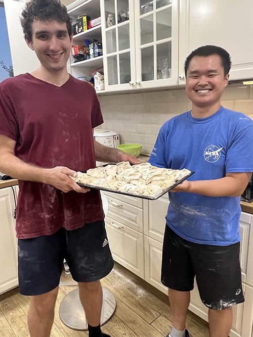 Devin Chen, right, and Danail Dimitrov pose in a kitchen with dumplings Chen made while on a trip to Bulgaria.