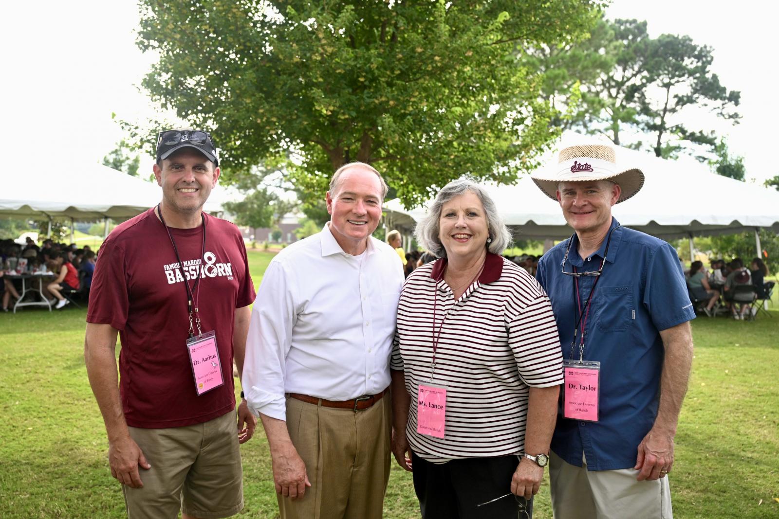 Pictured from left, Associate Director of Bands Craig Aarhus, MSU President Mark E. Keenum, Director of Bands Elva Kaye Lance and Associate Director of Bands Cliff Taylor during an Aug. 12 welcome-back dinner for the Famous Maroon Band at the Keenum home.