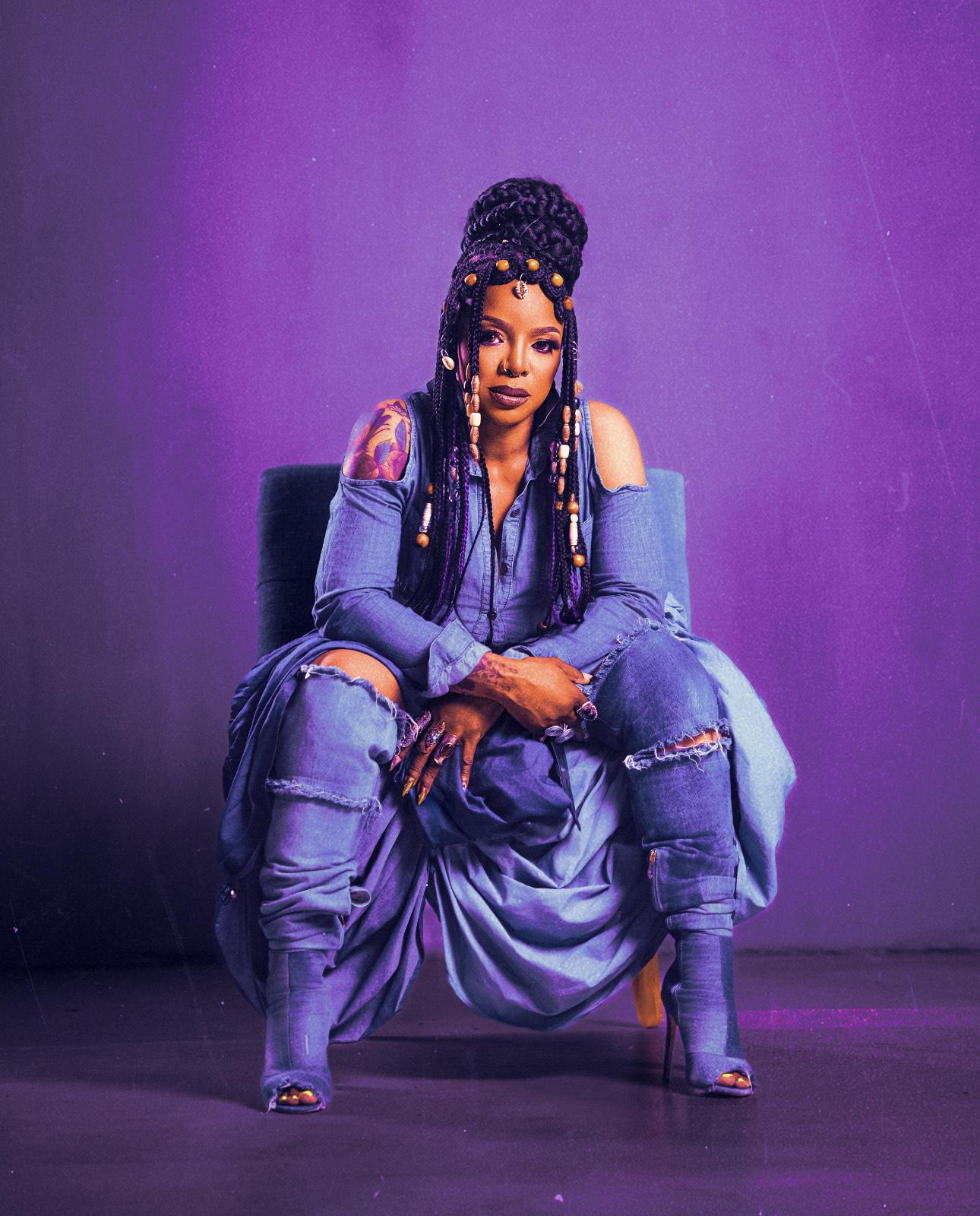 woman sitting in front of a purple background
