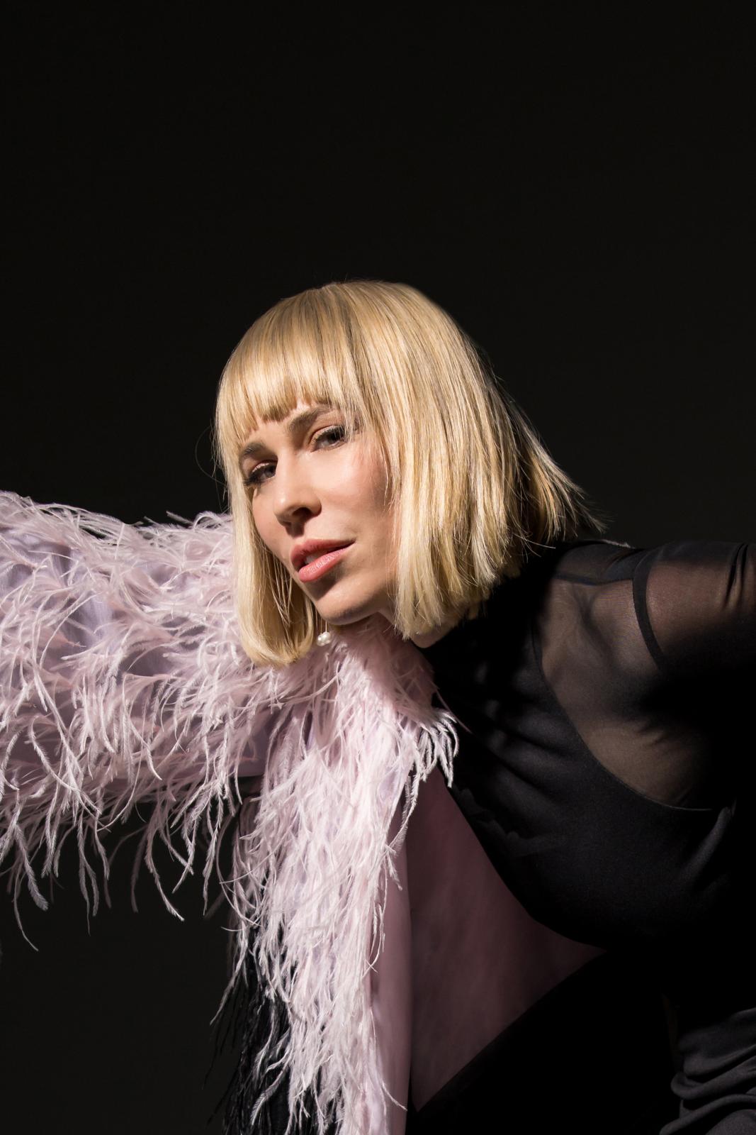 woman in white feathers posing