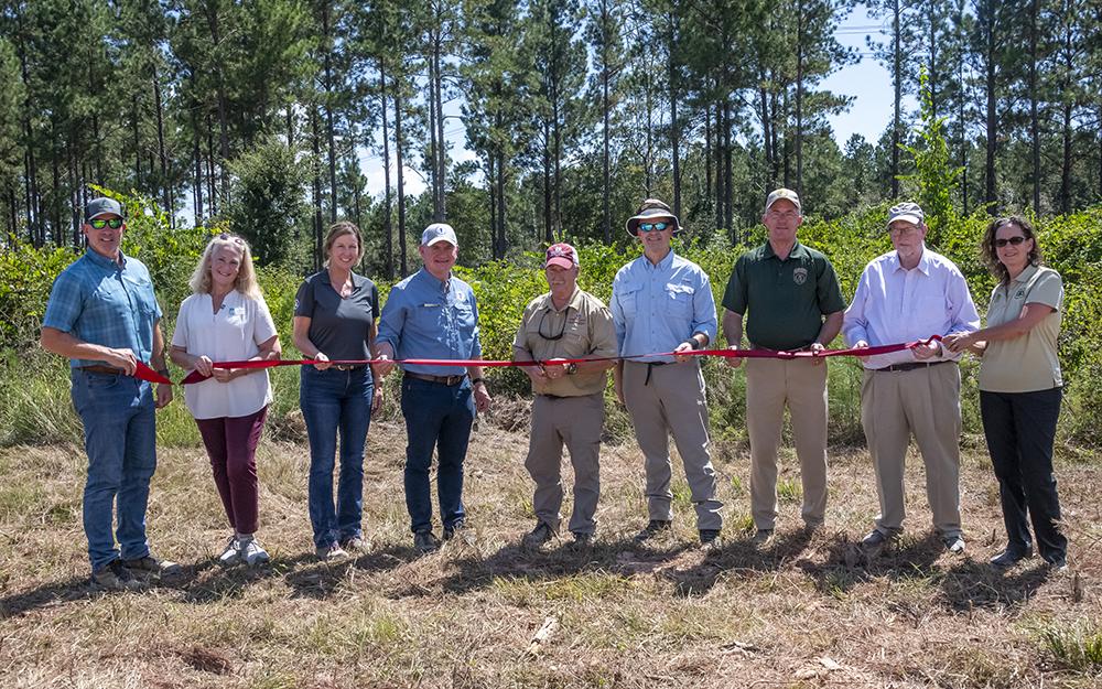 Attendees take part in a ribbon-cutting ceremony.