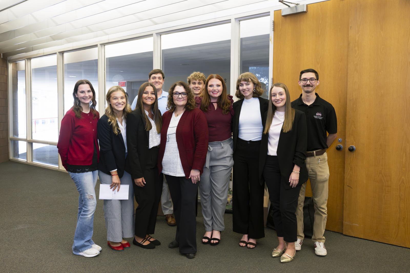 group of students in front of window