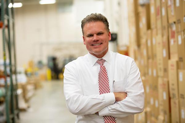 man in white shirt in front of boxes