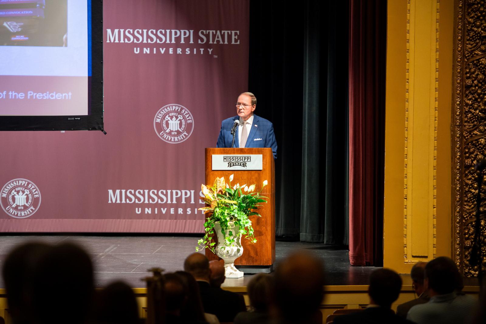 man speaking at podium