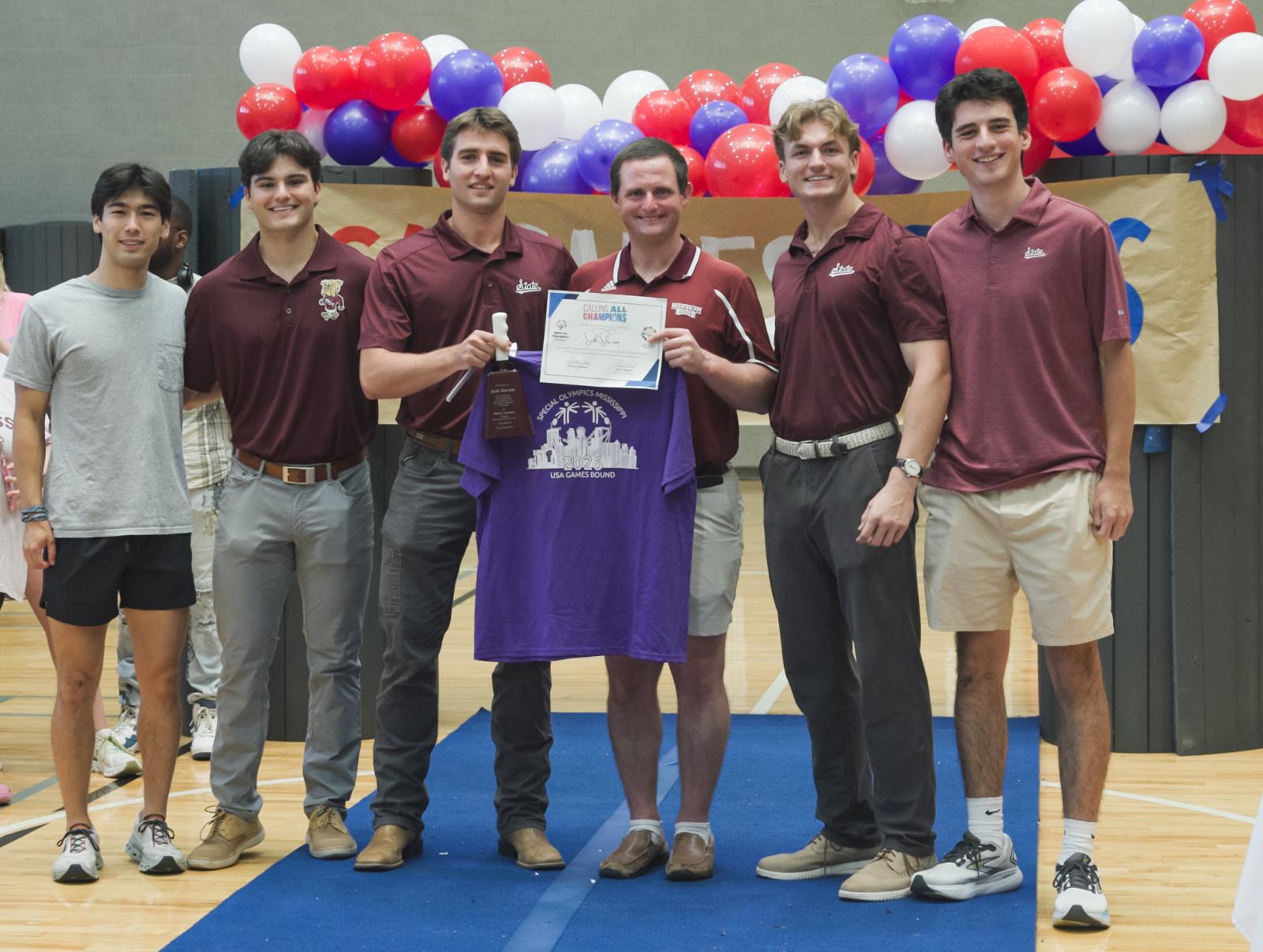 From left, trainers Owen Pope, Ethan Frost and August Jones, Seth Slocum, trainer Caden McGarity, and co-president for Mississippi State’s Special Olympics Unified Program Trace Cockrell are pictured celebrating Slocum’s participation at the 2026 Special Olympics USA Games next summer in Minnesota.