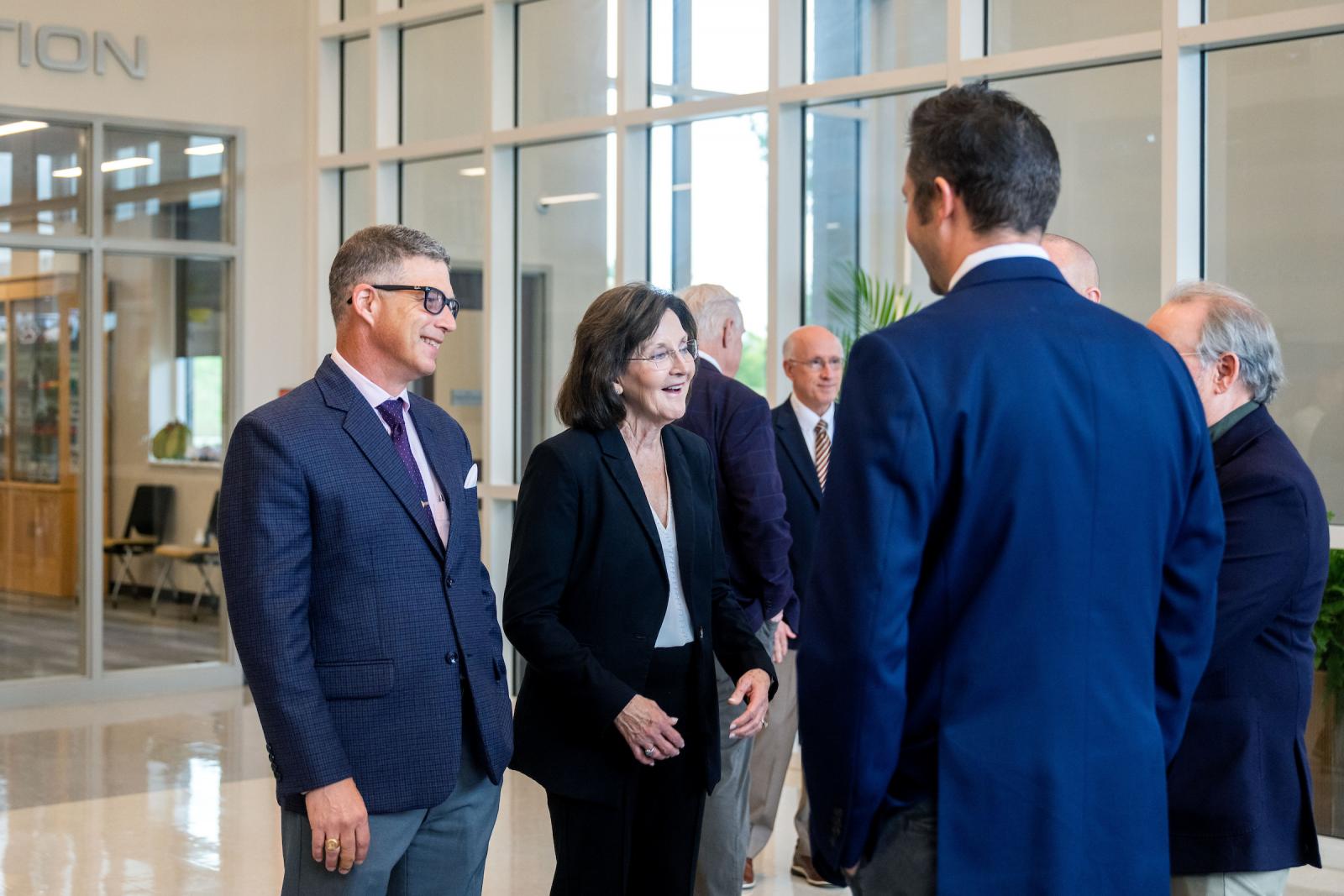 man and woman talk to another man