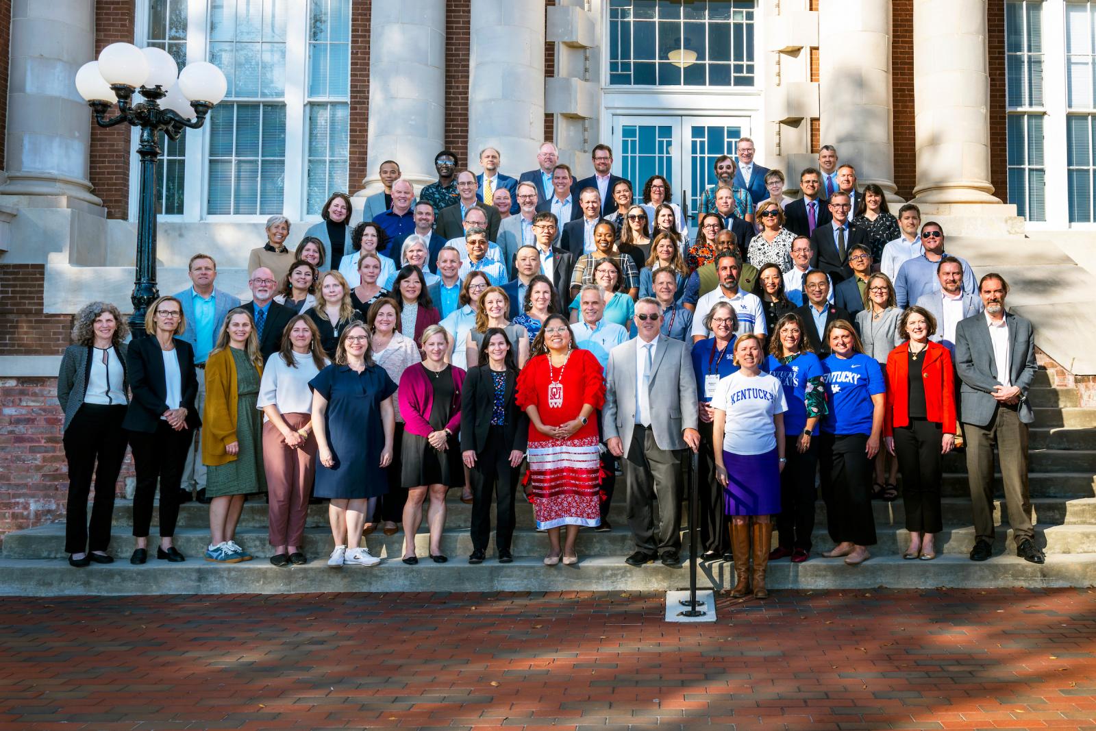 Group of people on steps of big building