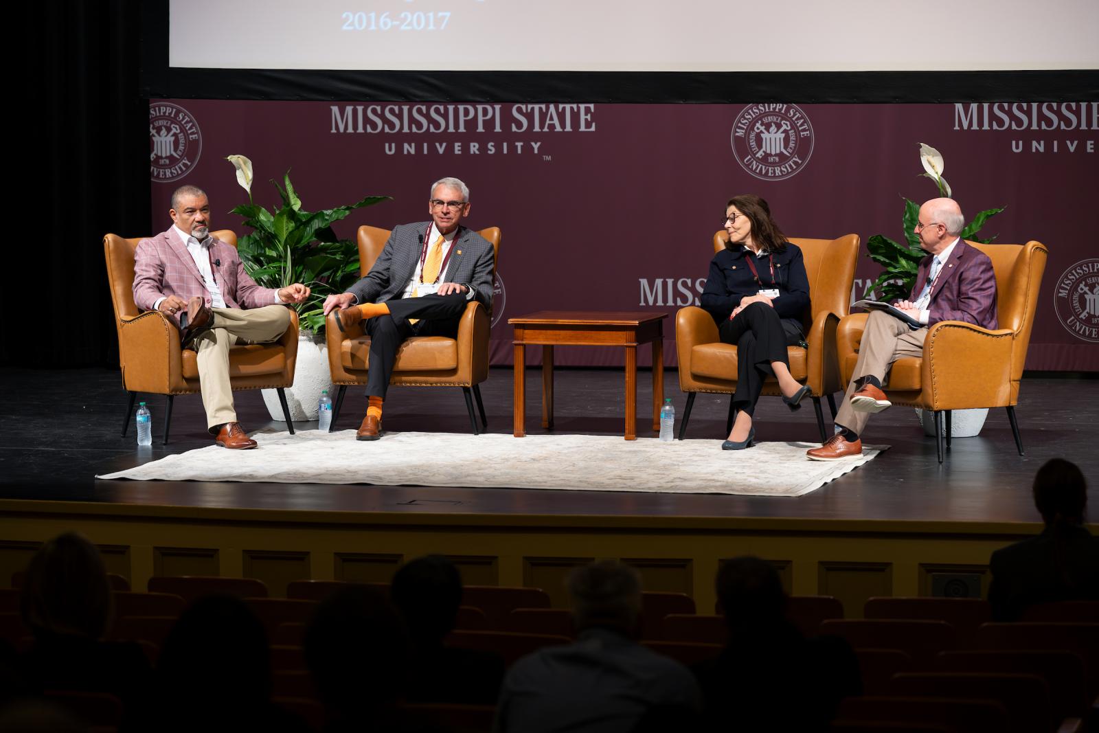 four provosts sitting on stage